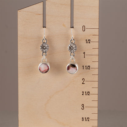 Handmade sterling silver dangle earrings with floral link accents and round pink and red dahlia jasper stones, featuring botanical artisan design with romantic charm.