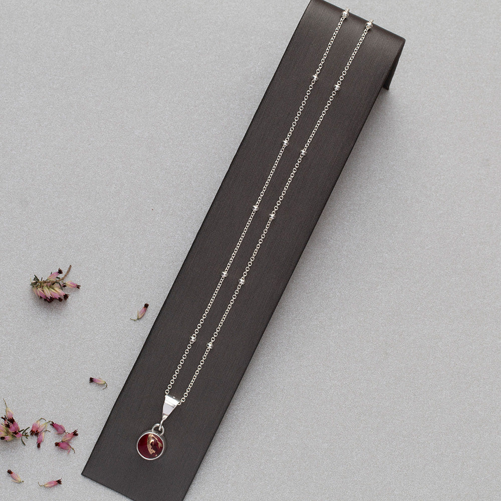 Full view of Dainty handmade sterling silver pendant necklace with round red and pink dahlia jasper stone, set on a fine chain with minimalist floral design and artisan elegance.