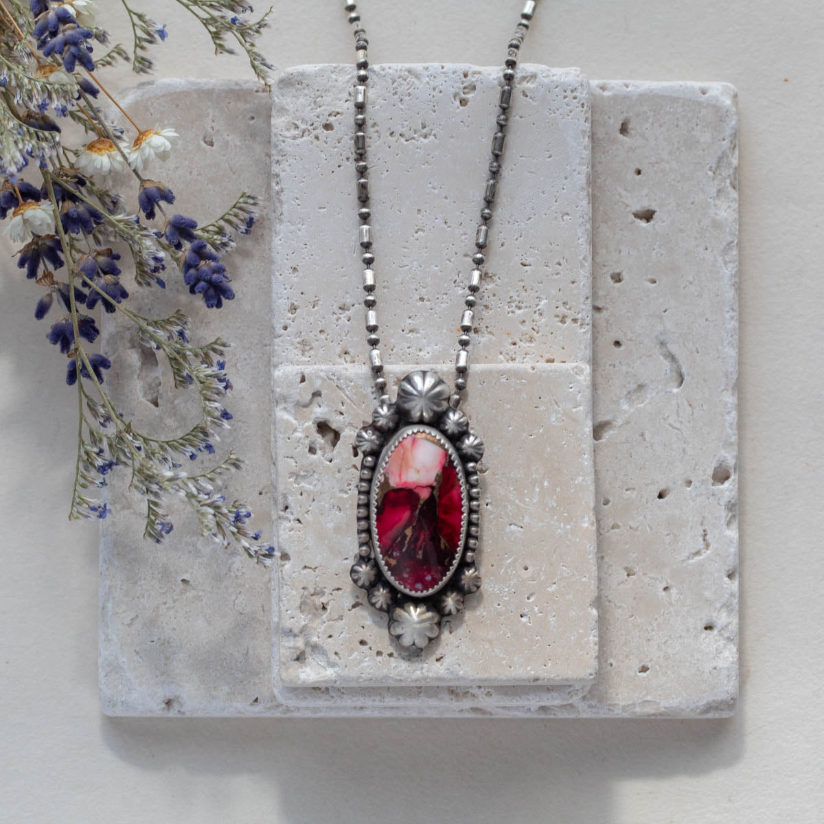 Handmade sterling silver pendant necklace featuring a red and pink dahlia jasper stone with floral accents, set in a decorative bezel on an oxidized beaded chain for a vintage botanical look.