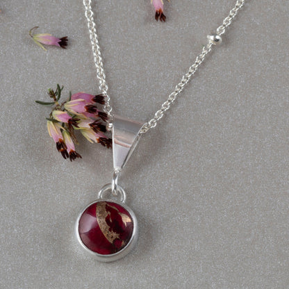 Dainty handmade sterling silver pendant necklace with round red and pink dahlia jasper stone, set on a fine chain with minimalist floral design and artisan elegance.”\