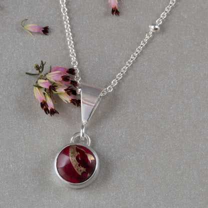 Dainty handmade sterling silver pendant necklace with round red and pink dahlia jasper stone, set on a fine chain with minimalist floral design and artisan elegance.”\