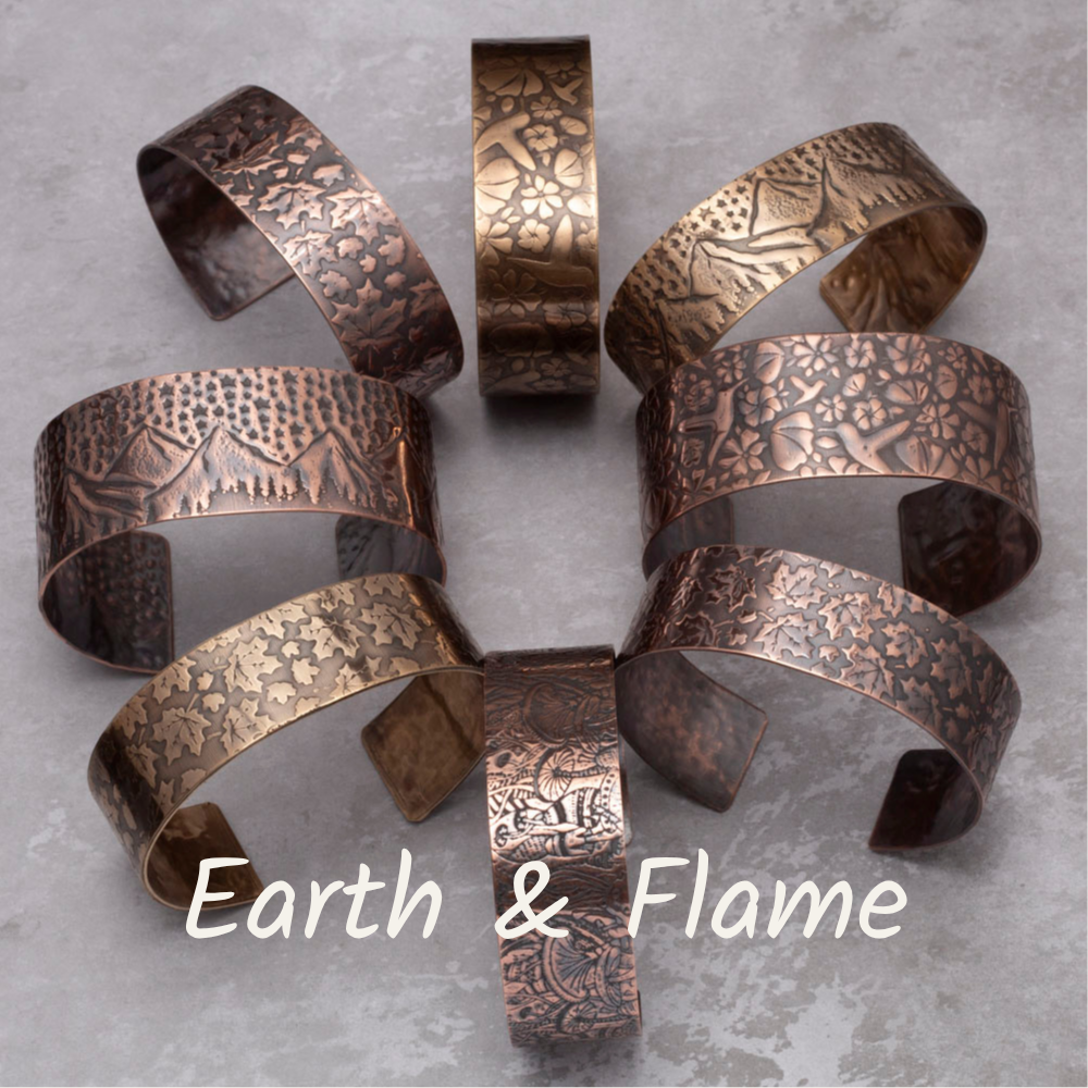 Set of copper bracelets with embossed patterns on a gray surface, branded 'Earth & Flame'.