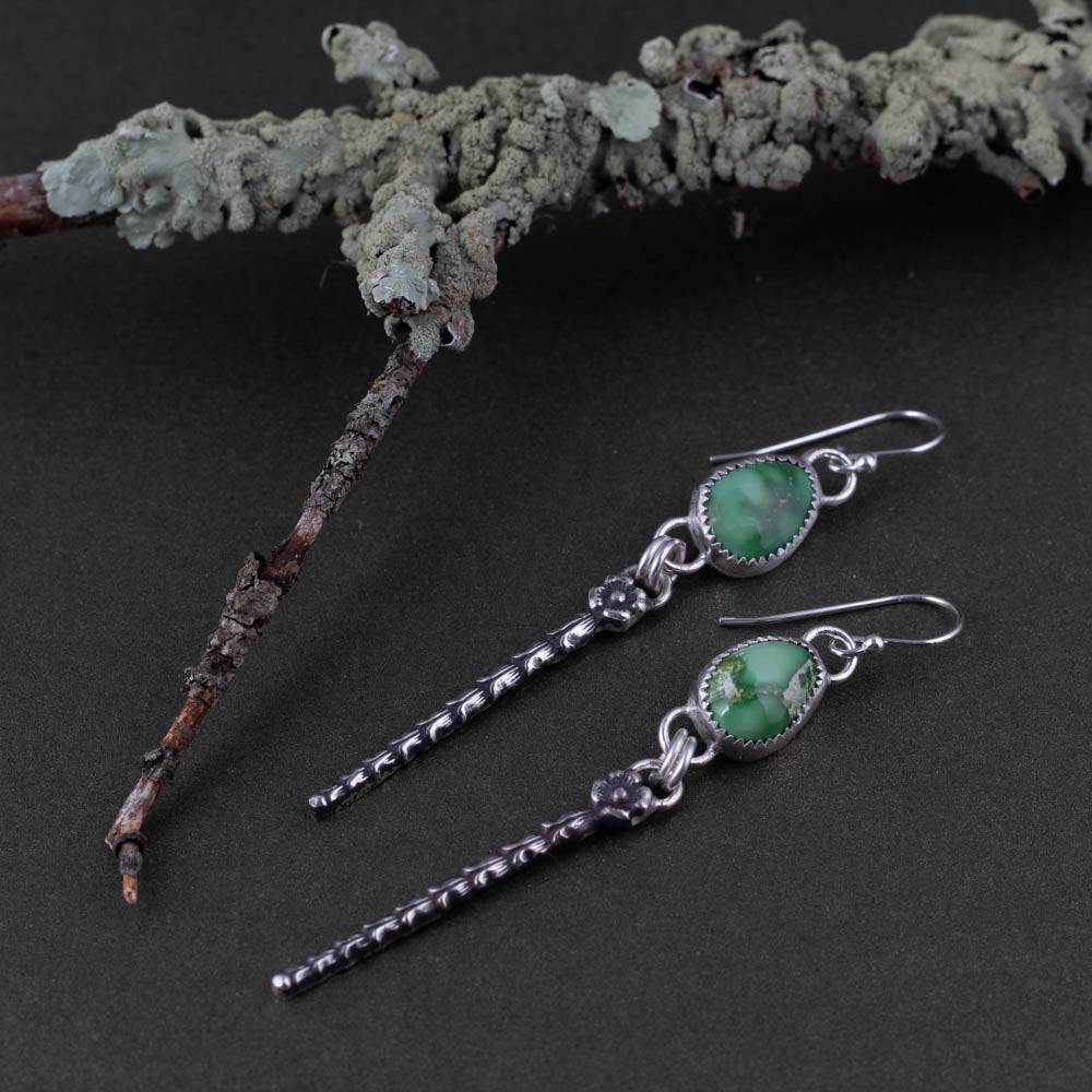 Emerald Valley turquoise artisan earrings photographed beside lichen covered branch