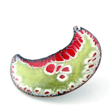 Crescent-shaped enamel pendant in red, green, and white with sterling silver bail