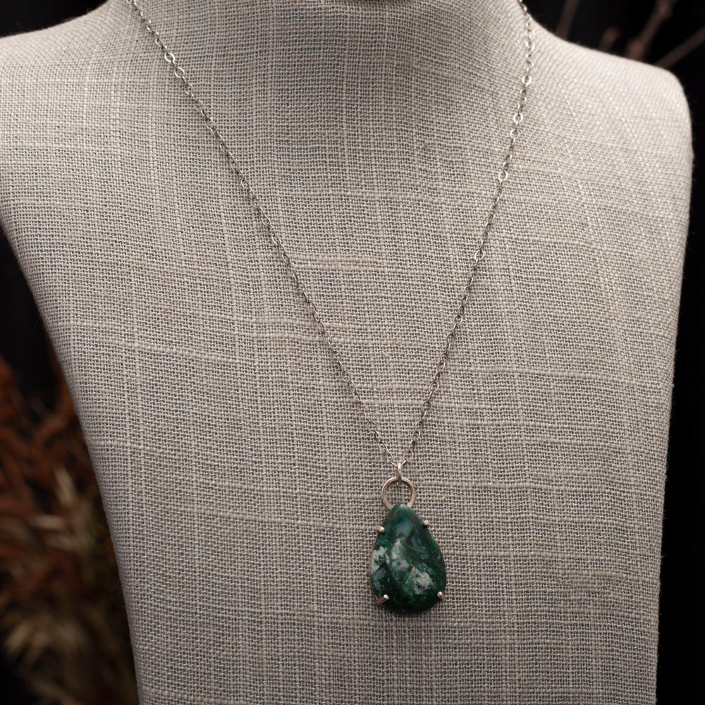 Teardrop-shaped green gemstone pendant with white inclusions on a sterling silver chain, handcrafted by Divella Designs.