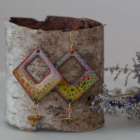 Vibrant handmade enamel earrings in red, yellow, and green with a canopy-inspired pattern, diamond shape cutouts, and gold-toned keshi pearl drops by Divella Designs.