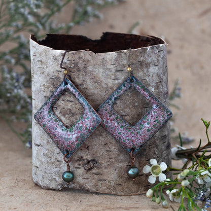 Handcrafted enamel earrings in pink, green, and white lichen pattern with diamond-shaped cutouts and freshwater pearl drops, woodland-inspired artisan jewelry by Divella Designs.