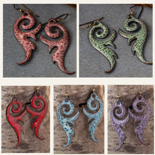 Set of four pairs of spiral-shaped earrings in different colors on a textured background.
