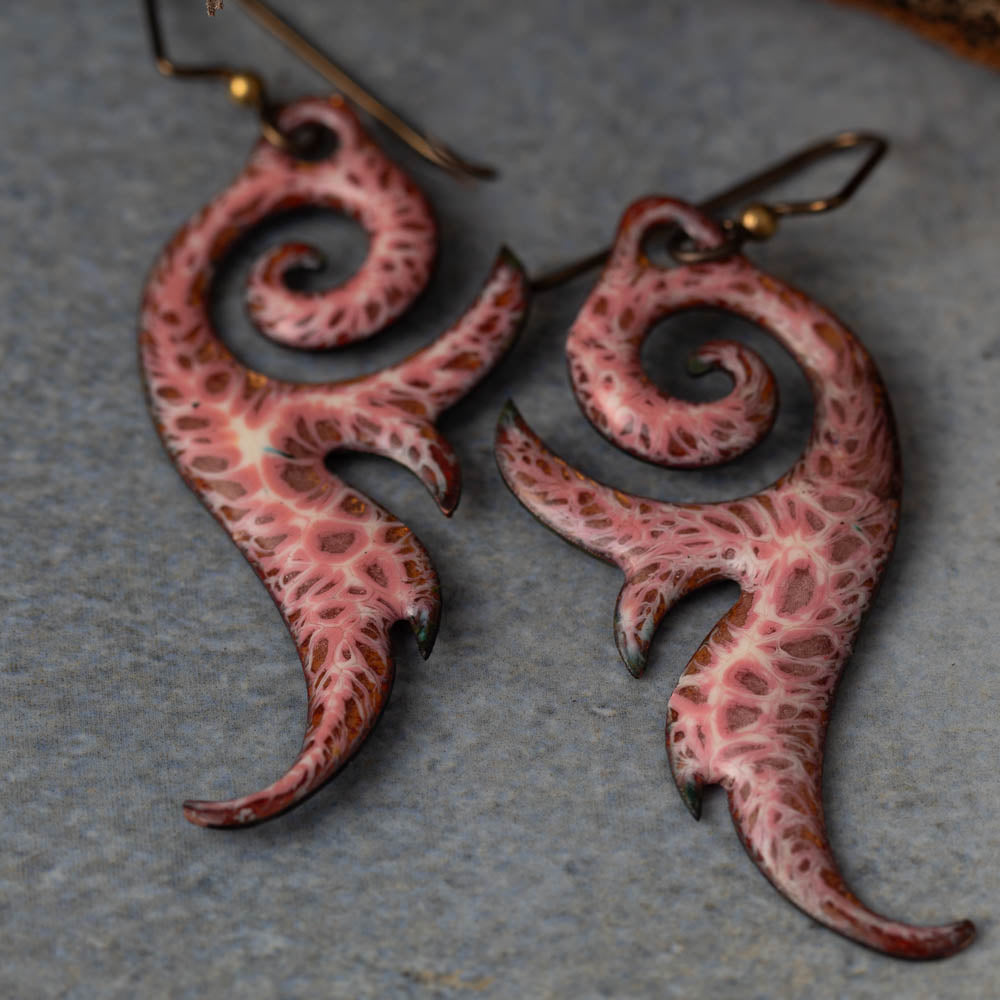 Handmade seaform curl earrings in kiln-fired enamel on copper with niobium ear wires. Lightweight, sculptural, and nature-inspired.