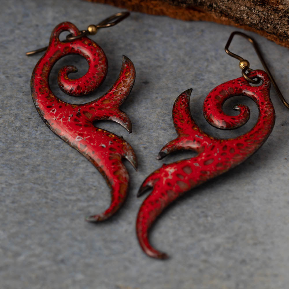Rust red frond enamel copper earrings with botanical shape and niobium ear wires, handmade by Divella Designs in Vermont.