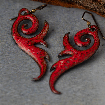 Rust red frond enamel copper earrings with botanical shape and niobium ear wires, handmade by Divella Designs in Vermont.