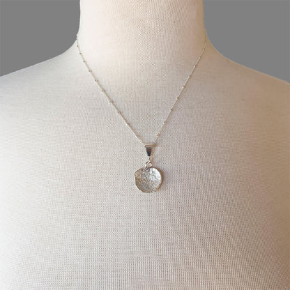 Fused silver dust necklace with organic lichen-like texture and sterling silver setting, handmade in Vermont by Divella Designs.
