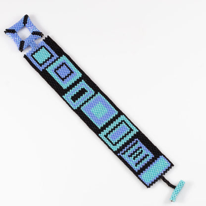 Fill view of beaded cuff bracelet with colorful geometric pattern on black background, fits 7 inch wrist