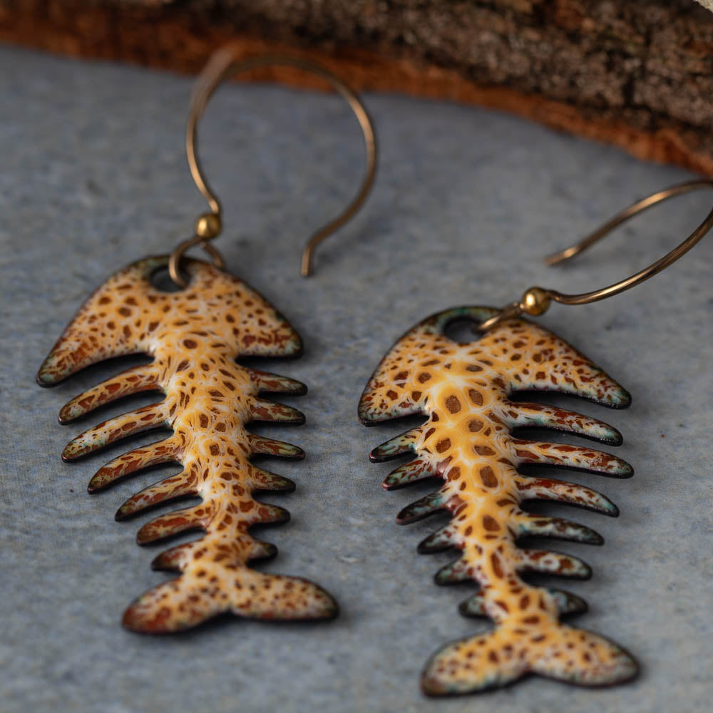 Colorful kiln-fired enamel fishbone earrings on copper with niobium ear wires, handmade by Divella Designs in Vermont.