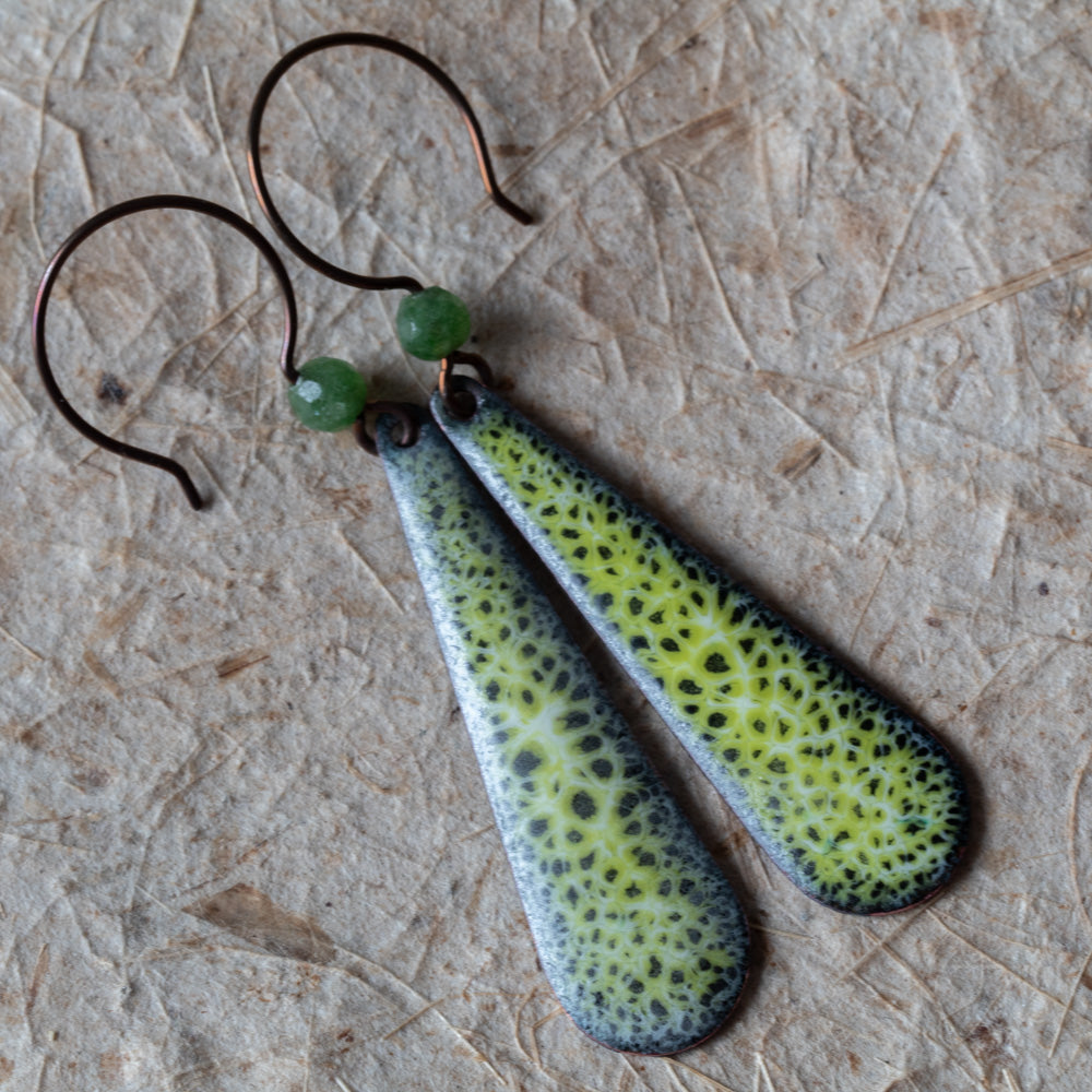 Green enamel teardrop earrings with lacy moss-like pattern, green semi-precious gemstone beads, and niobium ear wires.