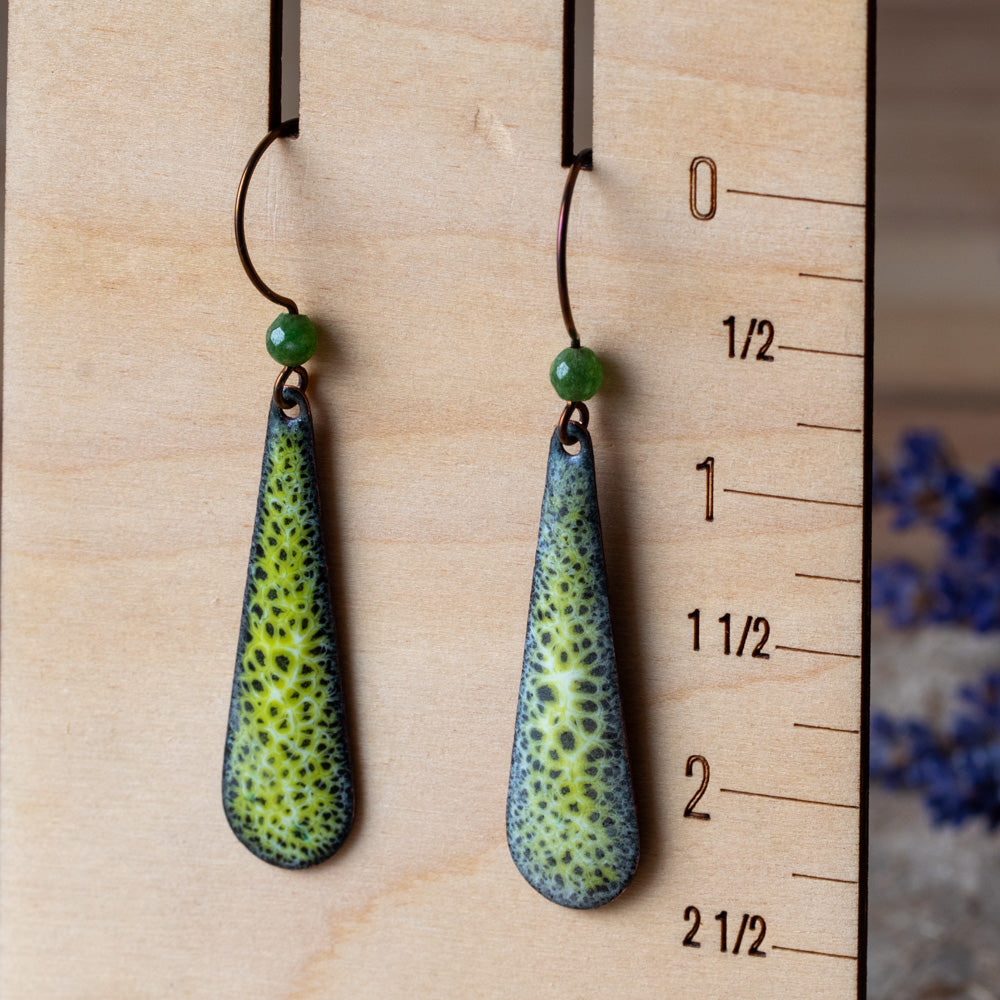 Green enamel teardrop earrings with lacy moss-like pattern, green semi-precious gemstone beads, and niobium ear wires.