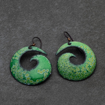 Handmade green enamel copper spiral earrings with organic wave-inspired shape and hypoallergenic niobium ear wires. Nature-inspired statement earrings.
