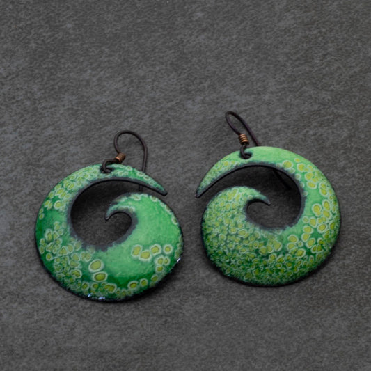 Handmade green enamel copper spiral earrings with organic wave-inspired shape and hypoallergenic niobium ear wires. Nature-inspired statement earrings.