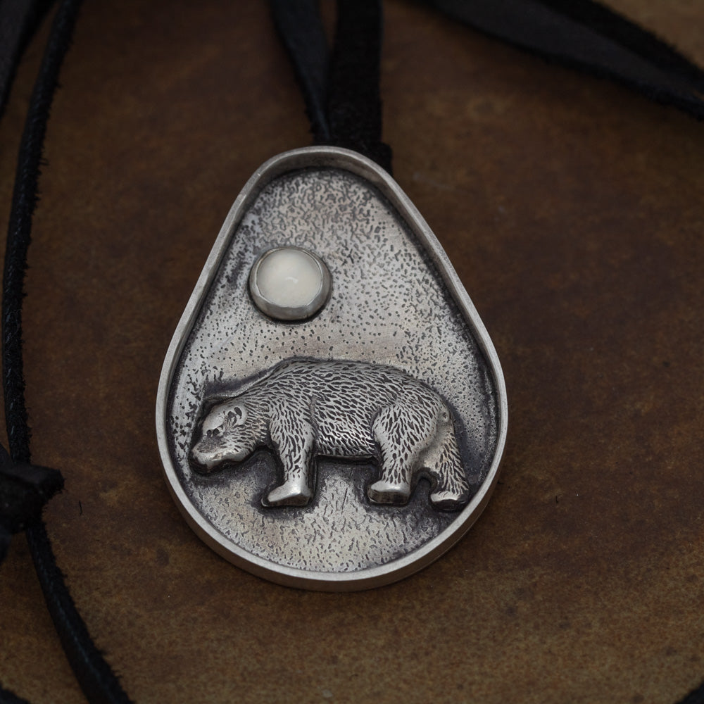 Close-up of handmade sterling silver bear pendant