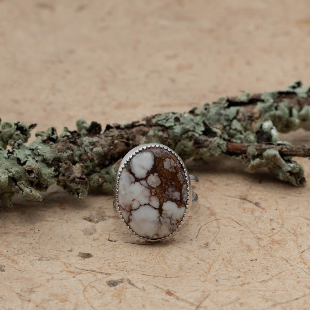 Silver and Wild Horse stone ring on bark with lichen covered branch on the background