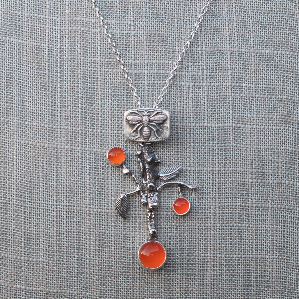AAA-grade carnelian orange branch pendant necklace shown on an 18-inch sterling silver rolo chain