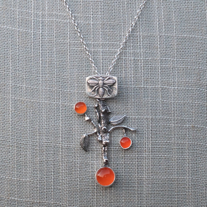 AAA-grade carnelian orange branch pendant necklace shown on an 18-inch sterling silver rolo chain