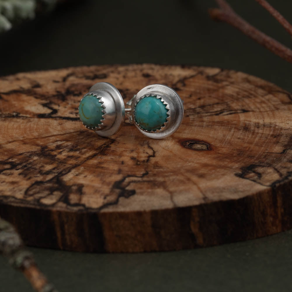 Handmade turquoise stud earrings in sterling silver with wide rim
