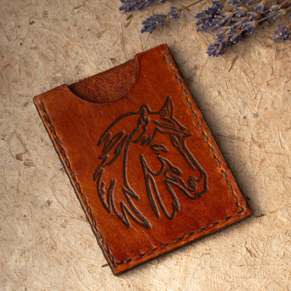 Handmade leather card case with embossed horse design. Compact size for cards or folded cash. Handmade in Vermont.