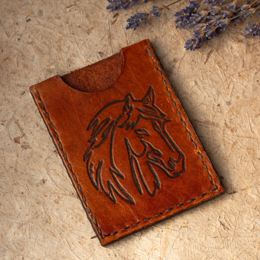 Handmade leather card case with embossed horse design. Compact size for cards or folded cash. Handmade in Vermont.