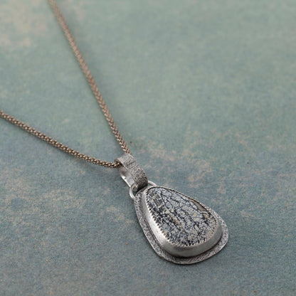 Handmade sterling silver Ivory Creek Variscite necklace with textured silver backplate and bail. Nature-inspired pendant on an 18" sterling silver popcorn chain.