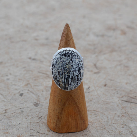 Sterling silver statement ring with an oval Ivory Creek Variscite stone in ivory, black, charcoal, and golden patterns.