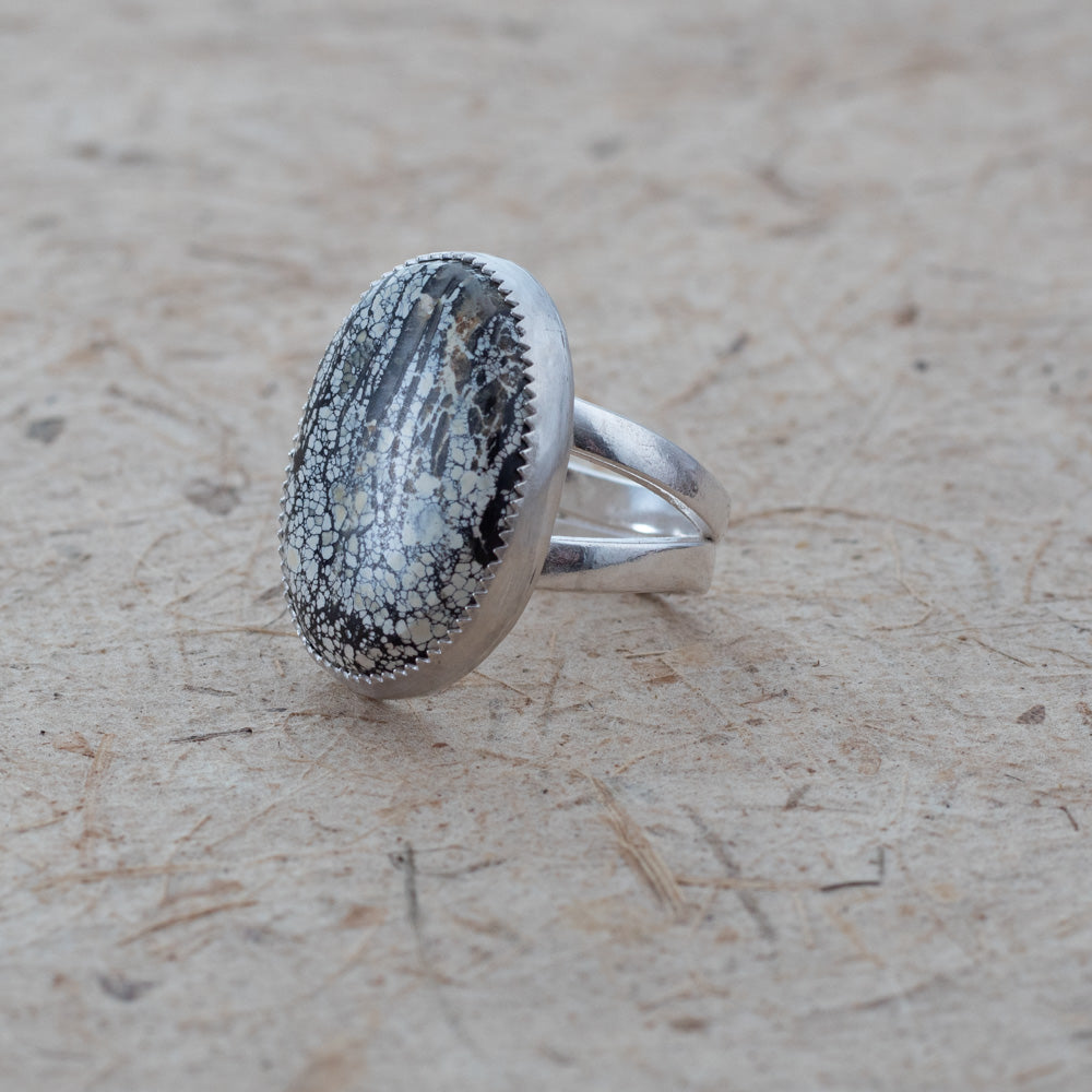 Silver ring with an Ivory Creek Variscite  stone on a textured beige surface
