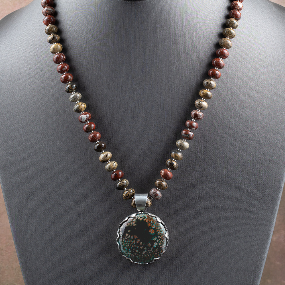 Enamel and jasper necklace with teal, black, and coppery kiln-fired enamel pendant in sterling silver bezel on a 20 inch jasper strand.