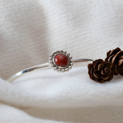 Sterling silver cuff bracelet with red jasper cabochon and beaded floral bezel, handmade jewelry