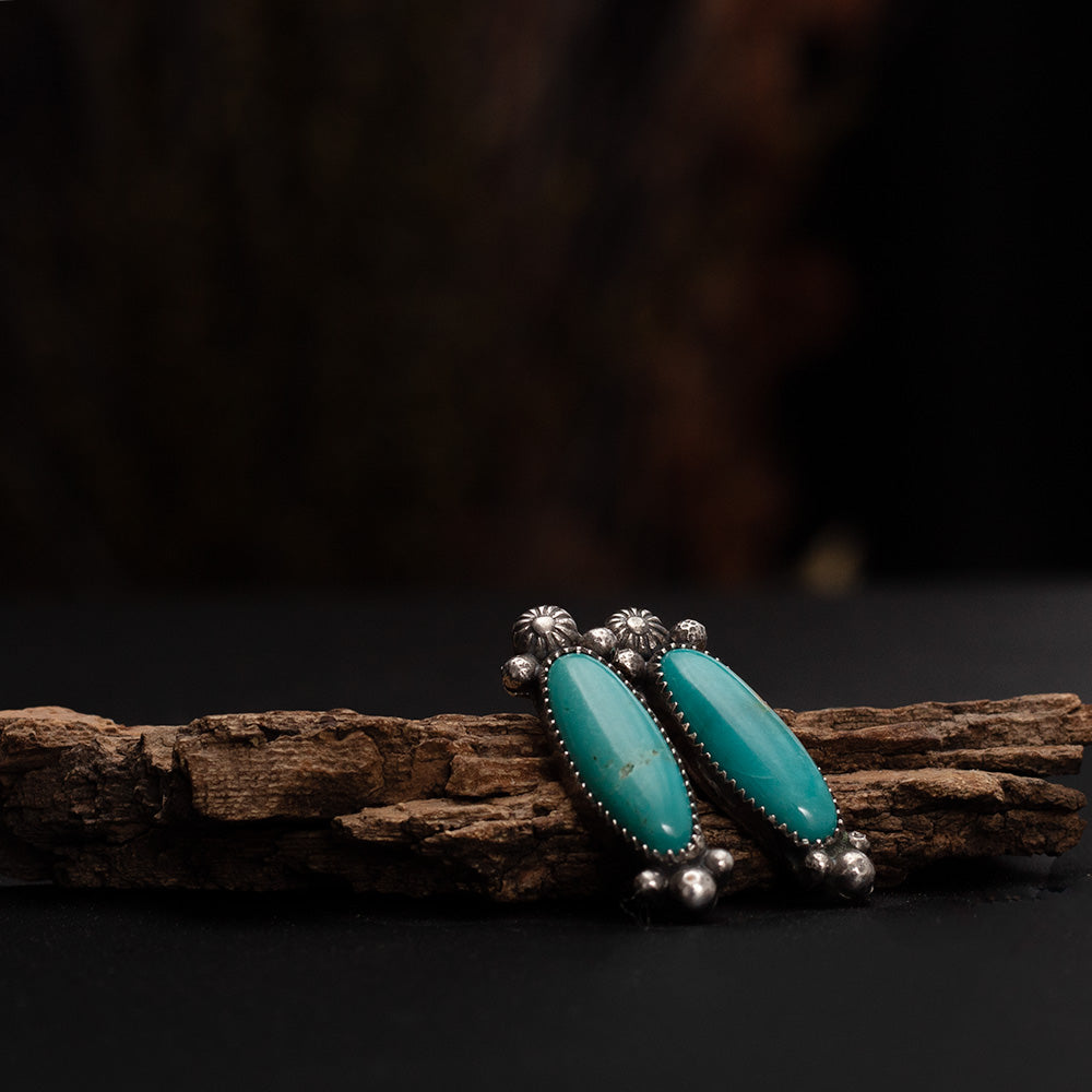 Handmade Kingman turquoise earrings in fine and sterling silver with floral sterling details, artisan crafted in Vermont.