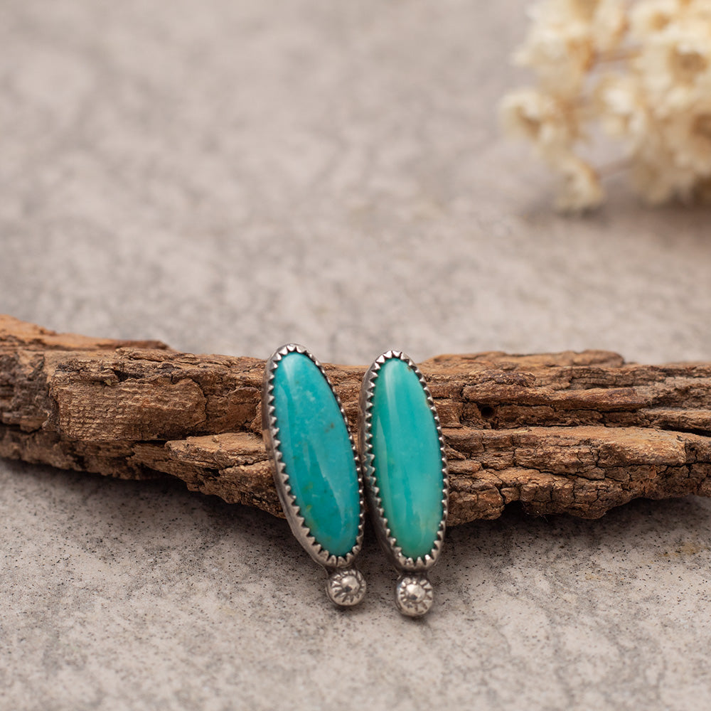 Kingman turquoise stud earrings with long oval blue-green stones, fine silver settings, and sterling silver posts, handmade by Divella Designs in Vermont.