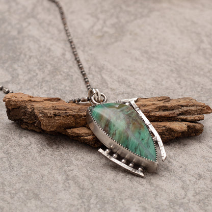 Handcrafted sterling silver pendant necklace featuring a green Kingman turquoise stone with modern geometric bezel setting on beaded chain.