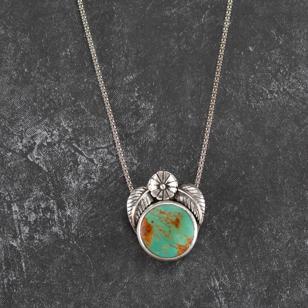 Kingman turquoise sterling silver necklace with 20mm blue-green stone, fine silver setting, silver leaves, flower accent, and 30 inch chain, handmade in Vermont by Divella Designs.