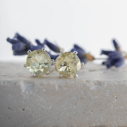 Sterling silver lemon quartz stud earrings on stone surface with lavender, handmade in Vermont.