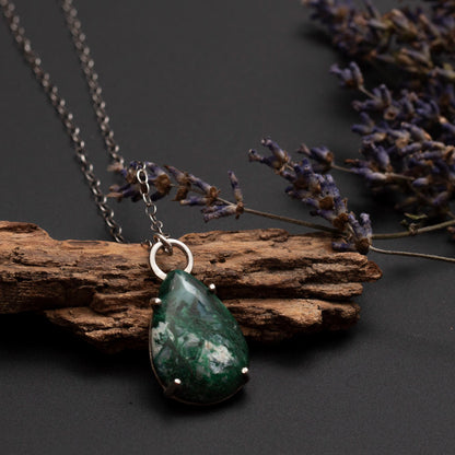 Teardrop-shaped green malachite pendant with white inclusions on a sterling silver chain, handcrafted by Divella Designs.