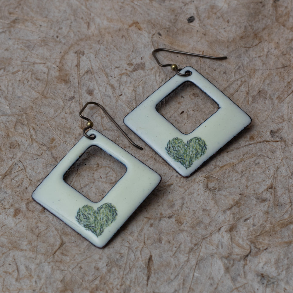 Cream enamel open square earrings with green meadow heart design, handmade in Vermont.