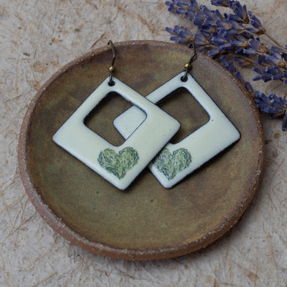 Cream enamel open square earrings with green meadow heart design, handmade in Vermont.