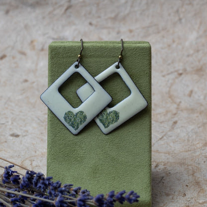 Cream enamel open square earrings with green meadow heart design, handmade in Vermont.