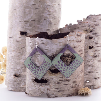 Mint green and purple enamel openwork earrings with petal-like patterning and sterling silver ear wires, handmade by Divella Designs.