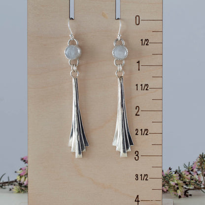 Handmade sterling silver dangle earrings featuring fan-shaped cascading drops and round moonstone gems, with minimalist artisan design and elegant movement.