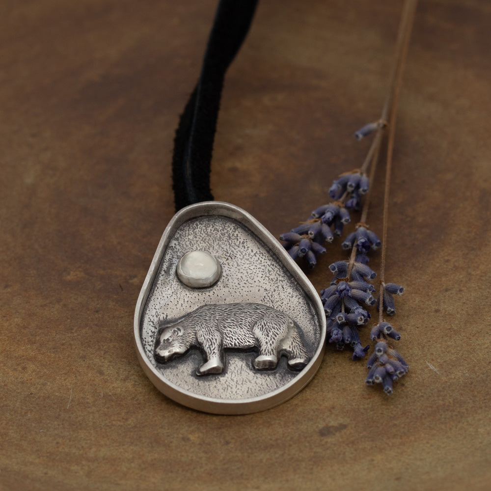Handmade sterling silver bear pendant with moonstone and oxidized textured background