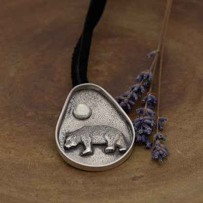 Handmade sterling silver bear pendant with moonstone and oxidized textured background