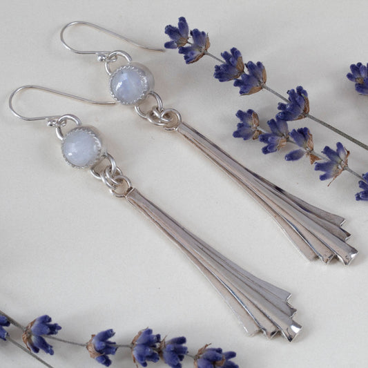 Moonstone sterling silver cascade earrings with pale glowing stones, long silver drops, and sterling silver ear wires, handmade by Divella Designs.