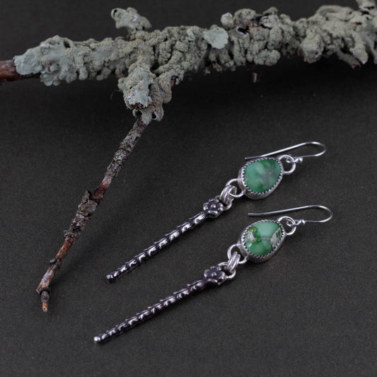 Emerald Valley turquoise artisan earrings photographed beside lichen covered branch