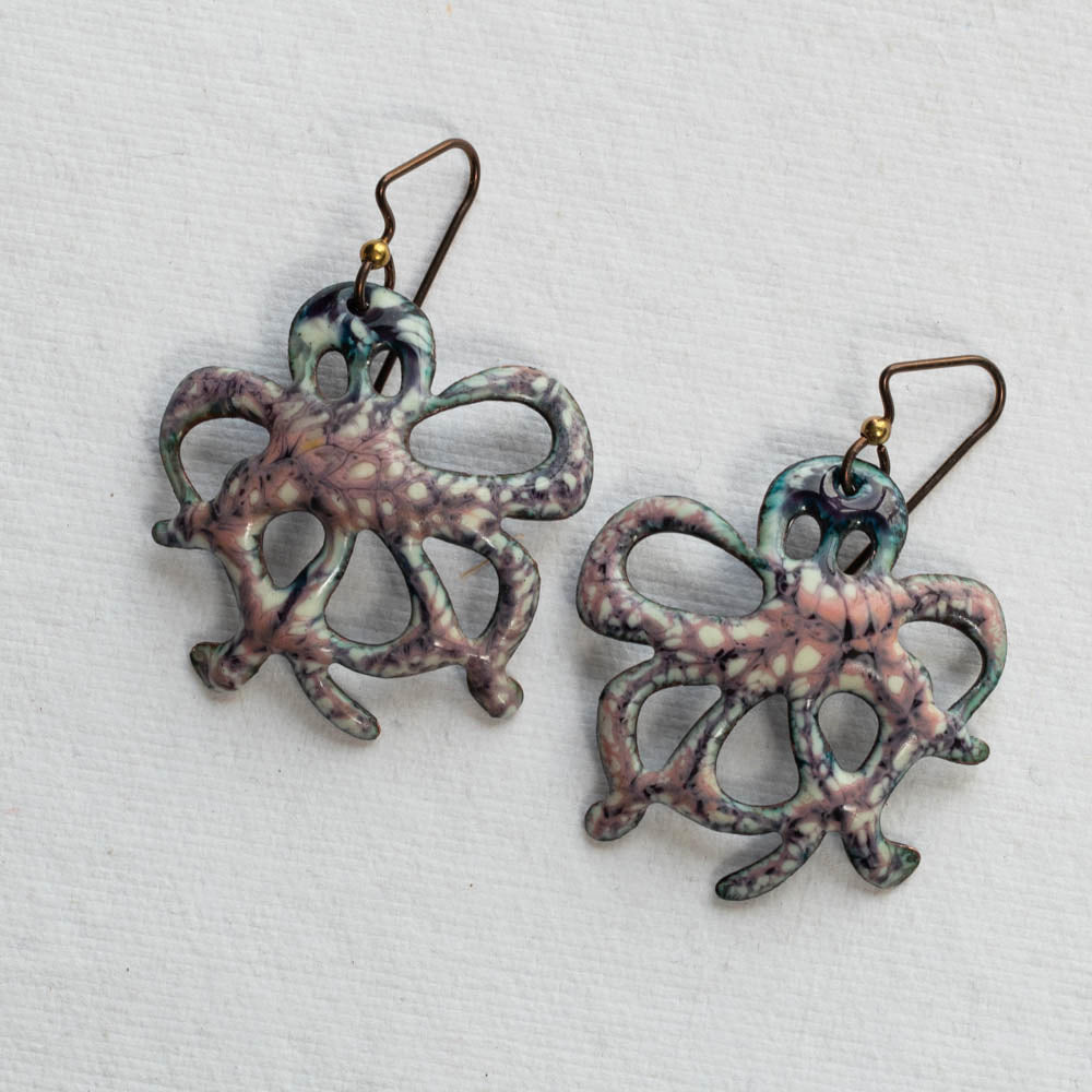 Pair of octopus-shaped earrings on a light gray background